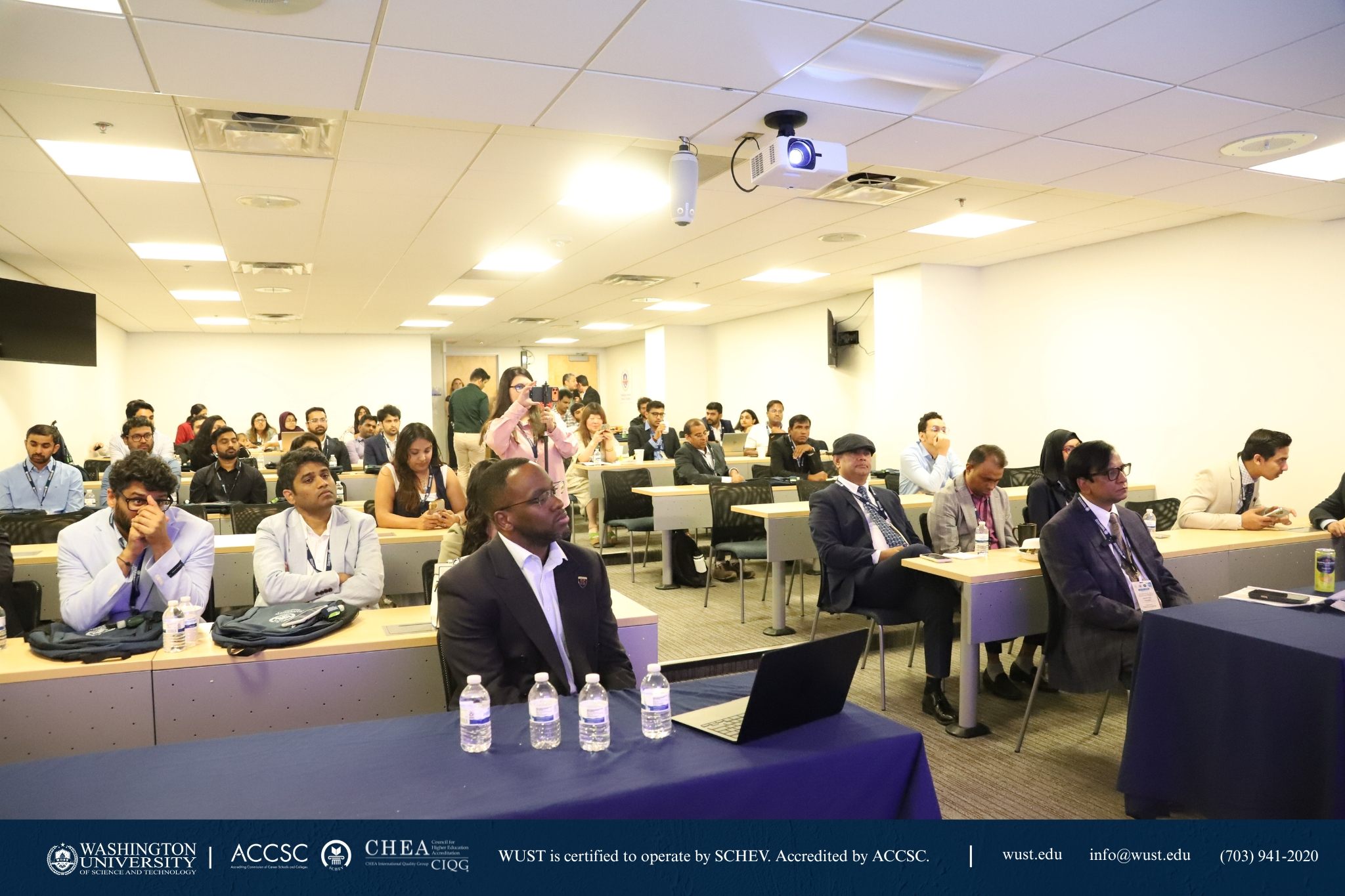 Audience listening to speakers at IJCACI 2026